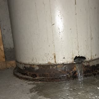 Photo of water leaking from the bottom of the water heater